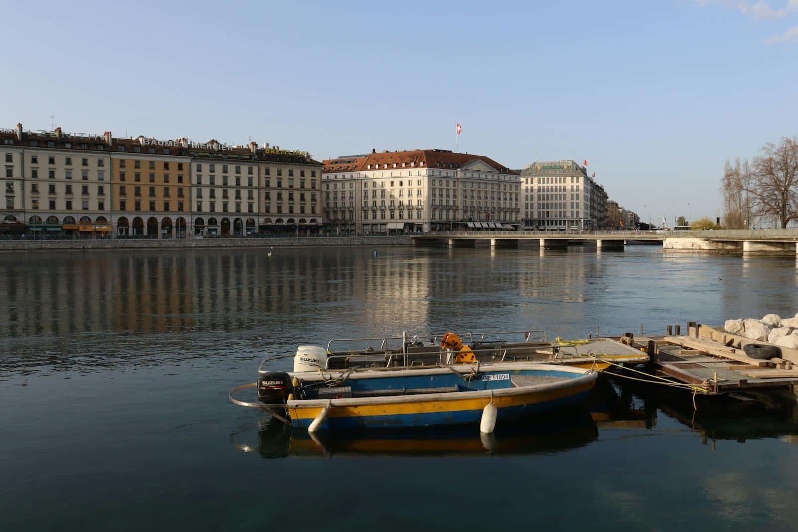 Docked Boats on Water Near City Buildings